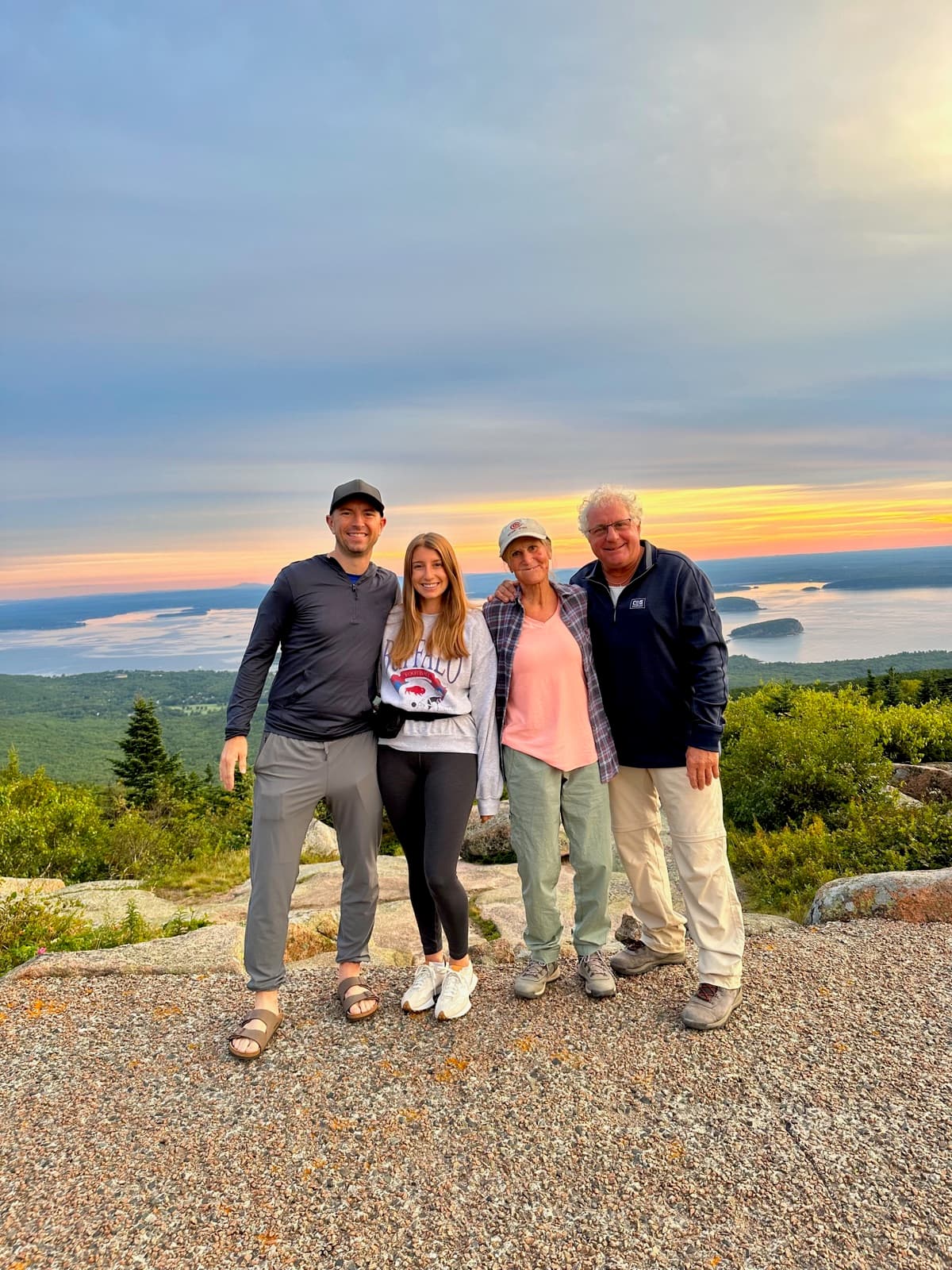 Brett with Erin and family at sunset on Cadillac Mountain in Acadia